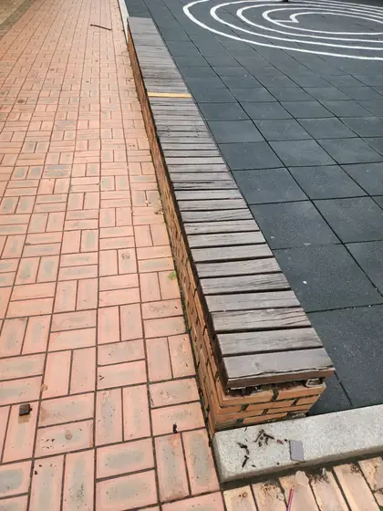 벤치 상판 교체 — 나무 상판을 얹은 긴 벽돌 벤치